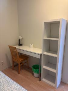 a desk with a chair and a book shelf at Quiet Private Rooms Easy Metro & Airport Access in Vantaa