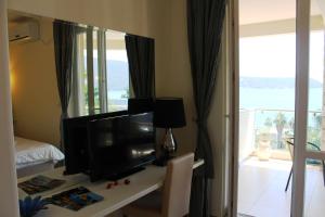 a living room with a tv and a mirror at Swiss Residence Montenegro in Herceg-Novi