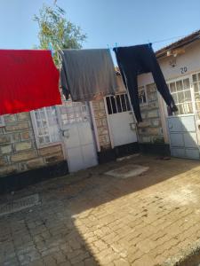 a house with red and black clothes hanging from clotheslines at Urban apartment in Eldoret