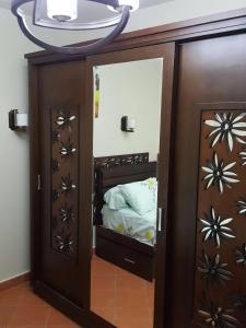 a small bedroom with a bunk bed with a mirror at Royal Chalet Porto Sokhna عائلات فقط in Ain Sokhna