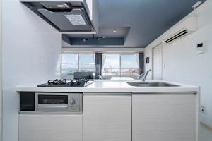a kitchen with a sink and a stove at Hills Garden 405 in Sapporo