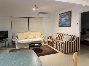 a living room with two couches and a tv at OCEAN GET AWAY in Rye