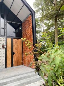 a brick house with a wooden door at Royal Brick Cottage, Jelebu in Kuala Kelawang