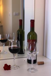 two bottles of wine and two glasses on a counter at Swiss Residence Montenegro in Herceg-Novi
