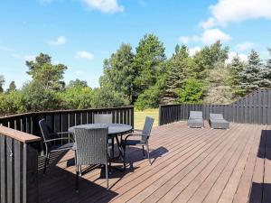 a patio with a table and chairs on a deck at 9 person holiday home in Jerup-By Traum in Jerup