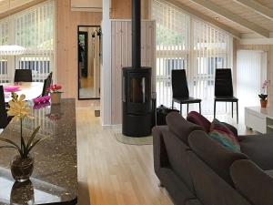 a living room with a couch and a wood stove at 9 person holiday home in Jerup in Jerup