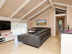 a living room with a couch and a table at 9 person holiday home in Jerup in Jerup