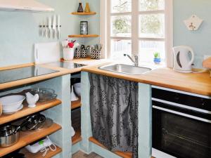 a kitchen with a sink and a counter at 5 person holiday home in Ans By in Roe