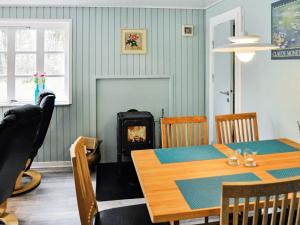 a dining room with a table and a wood stove at 5 person holiday home in Ans By in Roe +27 photos