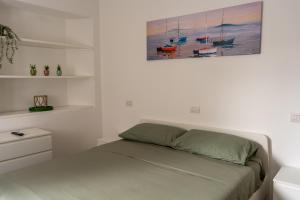a bedroom with a bed with a painting on the wall at Al Laghée - New 2 Bedroom Apartment in Gravedona Center in Gravedona