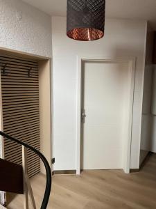 a hallway with a white door and a chandelier at Haus Ehrenfels in Bingen am Rhein