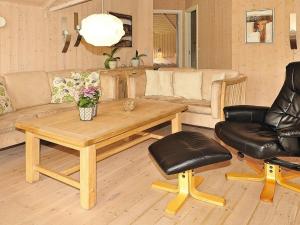 a living room with a table and a couch at 7 person holiday home in Ansager-By Traum in Ansager