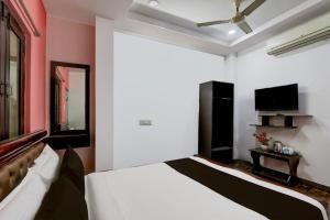 Ένα ή περισσότερα κρεβάτια σε δωμάτιο στο Hotel O Heavens Inn