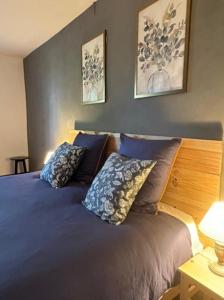 a bedroom with a bed with blue sheets and pillows at Les Chambres du 11 - Chambres et Table d'hôtes in Chevigny