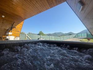 a large tub of water with a bird cage in it at Serra Luna Sibiel in Sălişte