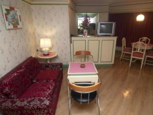 a living room with a couch and a table at Florida Hotel in Hat Yai