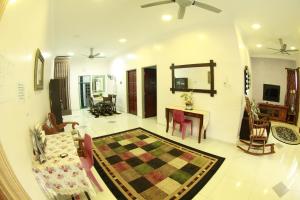 a large living room with a table and chairs at Twin Castle Homestay Kuala Pilah in Kuala Pilah