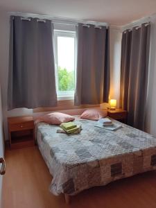 a bedroom with a large bed with a window at Sozopoli Hills, app B7 in Sozopol