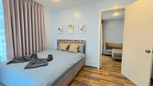 a bedroom with a bed with shoes on it at My Resort Huahin by Ying in Hua Hin +62 photos