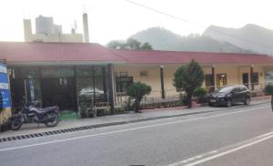 a motorcycle parked in front of a building on a street at Hotel Gauri & Restaurant in Jāmb
