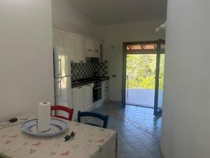 a kitchen with a table and a kitchen with a door to a patio at Vista mare montagna da Marcello in Cala Gonone