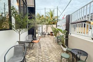 a patio with chairs and tables on a building at RedDoorz Plus at KAVA Living Syariah in Palas 2 +17 photos