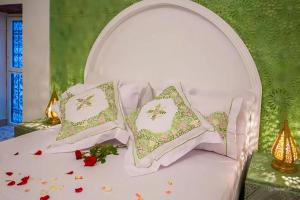 a white bed with three pillows on it at Riad Rayhana-Exclusive Riad Experience in Fes Medina in Fès +31 photos