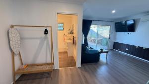 a living room with a couch and a window at King bedroom Collingwood in Riverview