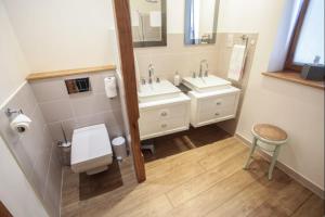 a bathroom with two sinks and two mirrors at La vie de château 2 in La Celle-sous-Gouzon