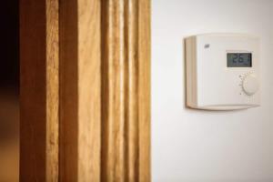 a lightswitch on a wall next to a door at La vie de château 2 in La Celle-sous-Gouzon