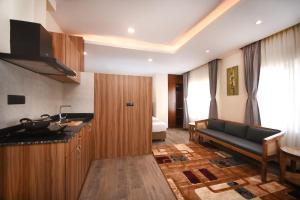 a kitchen with a black couch in a room at Hotel Cozy Heaven in Kathmandu