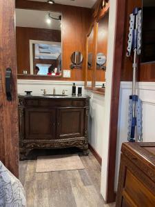 a bathroom with a sink and a mirror at Something to Write Home about in Cane Beds +30 photos