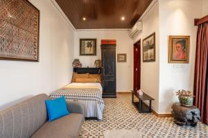 a bedroom with a bed and a couch at Villa Joglo Ayu in Uluwatu +21 photos