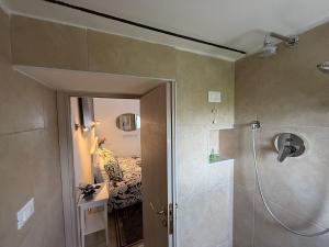 a bathroom with a shower and a bedroom with a bed at B&B Porta Verde in Castelbottaccio