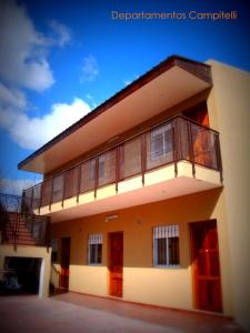 a building with a balcony on the side of it at Departamentos Campitelli in General Pacheco