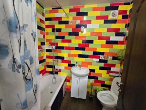a bathroom with multicolored tiles on the wall at Апартаменти CENTER in Uzhhorod