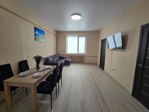 a living room with a table and a couch at Апартаменти CENTER in Uzhhorod