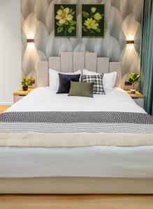 a bedroom with a large white bed with pillows at Апарт-отель Urban Luxe Mirabad 8 in Toshkent-Passajir Bekati