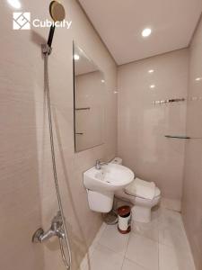 a bathroom with a sink and a toilet and a shower at Cubicity Hidden House in Ho Chi Minh City