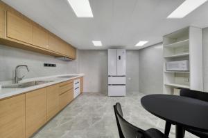 a kitchen with a table and a dining room at Wander Lodge Youth Hostel in Chengdu +34 photos