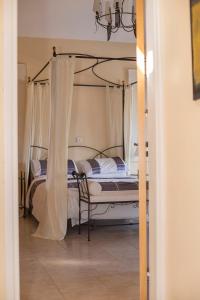 a bedroom with a bed with a canopy at Villa Pelagia Secret Valley Paphos in Kouklia +22 photos