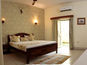 a bedroom with a bed in a room with a window at Madhav's Mallet - A Boutique Homestay in Jaipur