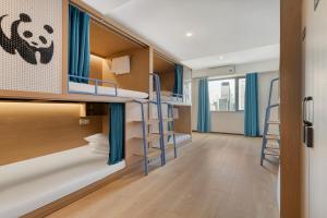 a hostel room with bunk beds with blue curtains at Wander Lodge Youth Hostel in Chengdu