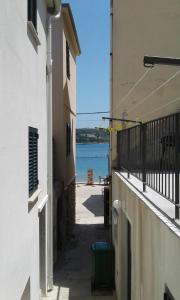a hallway between two buildings with a view of the water at Villa Neka in Primošten