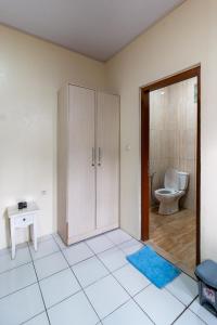 an empty bathroom with a toilet and a cabinet at Jayagiri Guesthouse By Belgareti in Lembang