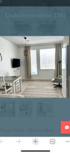 a living room with a table and a dining room at Studio Lintulammentie in Oulu