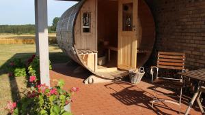 a circular house with a table and a chair on a patio at Ferienwohnung Gurvitz in Rambin +4 photos