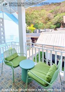 a patio with two chairs and a table on a porch at Koh Larn White House in Ko Larn