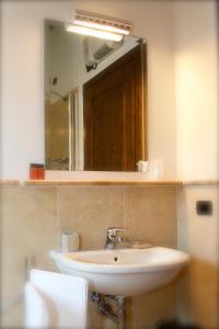 a bathroom with a sink and a mirror at Rosso Porpora in Colle Umberto +49 photos