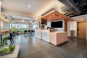 an office with a reception desk and a dining area at Wander Lodge Youth Hostel in Chengdu